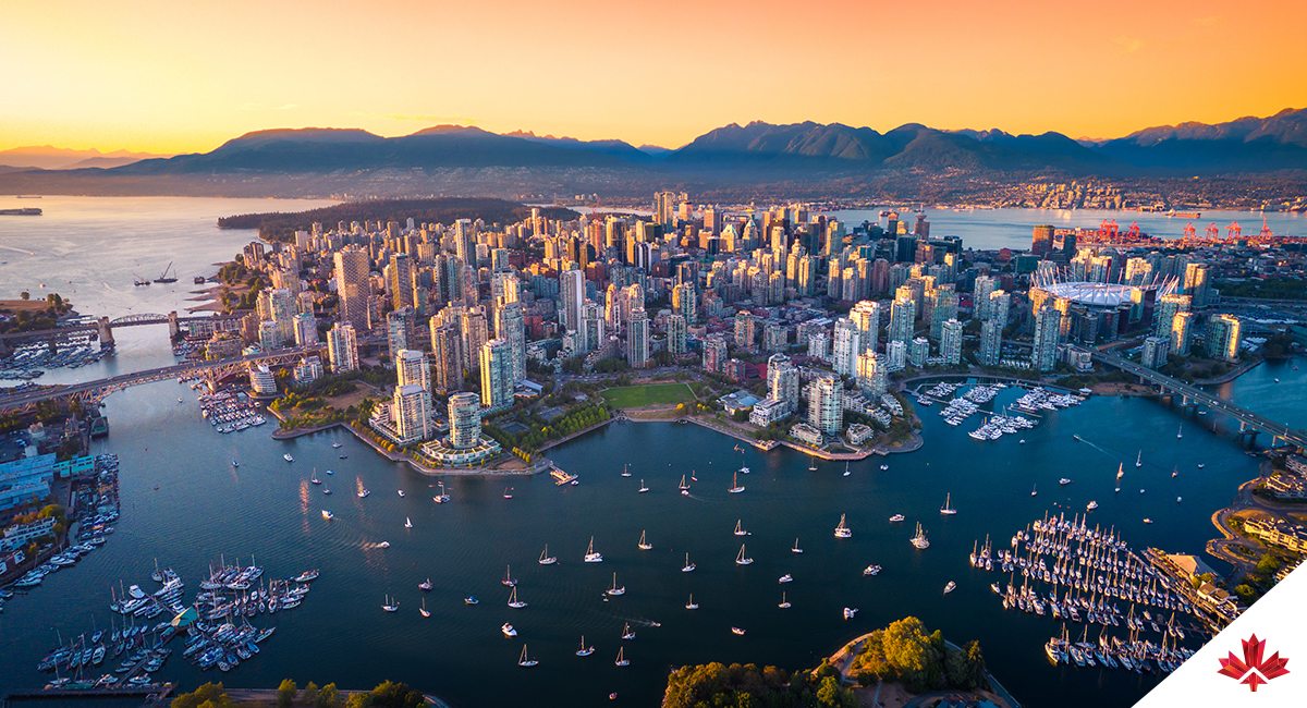 Aerial view of downtown Vancouver, British Columbia, including office and residential buildings, Vancouver Harbour, English Bay, boats and bridges.