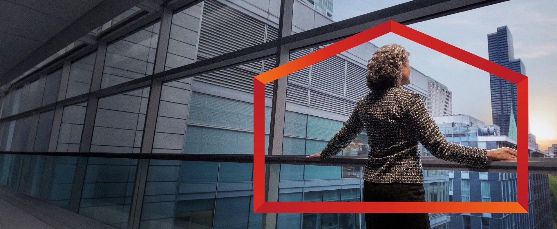 A female is seen from behind, standing and looking out a large, floor-to-ceiling window or balcony. The person is wearing a dark, professional-looking jacket, with their hands resting on a dark horizontal railing. Beyond the window, a modern cityscape is visible with multiple tall, glass-fronted buildings in Canada.